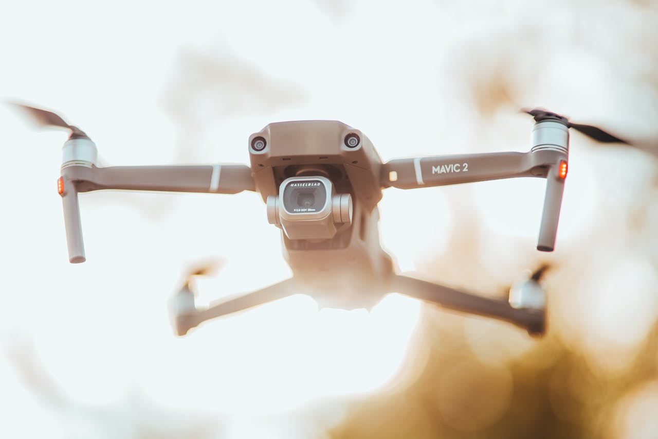 A detailed close-up of the Mavic 2 drone in flight against a blurred outdoor background.